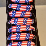 Red, White and Blue Shoelaces  Black high top chuck with wide print red, white and blue shoelaces.