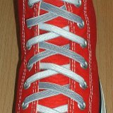 Reversible Shoelaces On Chucks  Red high top with gray and white reversable laces.