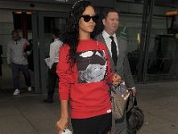 Rihanna  Rihanna at Heathrow Airport wearing black high top chucks.