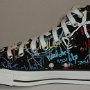 Rock and Roll High Top Chucks  nside patch view of a right black punk print high top.