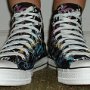 Rock and Roll High Top Chucks  Wearing black punk print high tops, front view 1.
