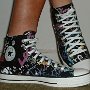 Rock and Roll High Top Chucks  Wearing black punk print high tops, left side view 2.