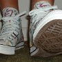 Rock and Roll High Top Chucks  Wearing white punk print high tops, front view 2.