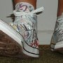 Rock and Roll High Top Chucks  Wearing white punk print high tops, front view 3.