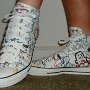 Rock and Roll High Top Chucks  Wearing white punk print high tops, left side view 2.