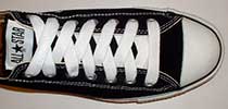 White retro shoelaces on black low top