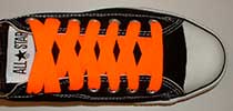Neon orange retro shoelaces on black low tops