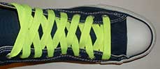 Neon yellow retro shoelace on navy blue high top