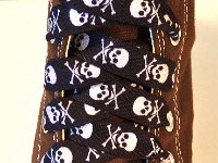 Skull Print Shoelaces On Chucks  Black and white skull print shoelace on a chocolate brown high top.