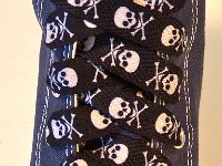 Skull Print Shoelaces On Chucks  Black and white skull print shoelace on a navy blue high top.
