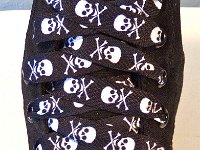 Skull Print Shoelaces On Chucks  Black and white skull print shoelace on a monochrome black high top.