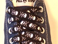 Skull Print Shoelaces On Chucks  Black and white skull print shoelace on a navy blue low cut.