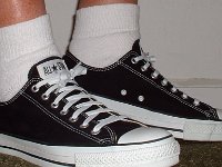 Socks for Your Chucks  All white quarter high socks worn with black low cuts, right side view.