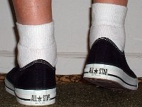 Socks for Your Chucks  All white quarter high socks worn with black low cuts, rear view.