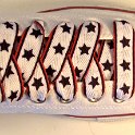 Star Print Shoelaces on Chucks  Optical white high top chuck with black, white and red star print shoelaces.