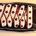 Star Print Shoelaces on Chucks  Black low top chuck with black, white and red star print shoelaces.