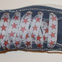 Star Print Shoelaces on Chucks  Navy blue high top chuck with red and silver star print shoelaces.