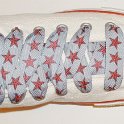 Star Print Shoelaces on Chucks  Optical white high top chuck with red and silver star print shoelaces.