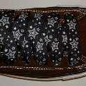 Star Print Shoelaces on Chucks  Chocolate brown low top chuck with black and silver star print shoelaces.
