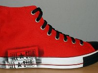 Stencil Chucks  Outside view of a right red stencil high top with black toe cap, toe guard, and laces.