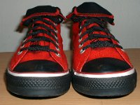 Stencil Chucks  Front view of rolled down red stencil high tops with black toe caps, toe guards, and laces.