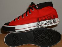 Stencil Chucks  Outside and sole views of rolled down red stencil high tops with black toe caps, toe guards, and laces.