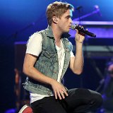 The Summer Set  Brian Dales kneeling down in performance, sporting his red zipper high top chucks.