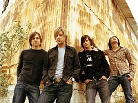 Switchfoot  Posed shot of the band, with guitarist Drew Shirley wearing black chucks.