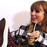 Taylor Swift  Taylor sipping a drink while wearing studded maroon high top chucks.