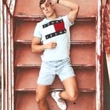 Teen Boys Wearing Chucks  Teen lying down on a staircase wearing a Tommy Hilfinger tee shirt, pale blue shorts, and optical white hight op chucks with white crew socks.