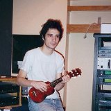 The Strokes  In the studio. Albert Hammond Jr. casually dressed in a white tee shirt, torn jeans, and well worn red chucks plays the ukelele.