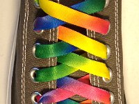 Tie Dye Shoelaces on Chucks  Charcoal grey low cut chuck with rainbow tie dye shoelaces.