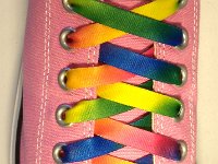 Tie Dye Shoelaces on Chucks  Pink low cut chuck with rainbow tie dye shoelaces.