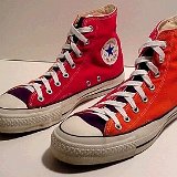 Tri-Color Chucks  Angled side view of red, orange, and black tri-color high tops.