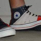 Tri-Color Chucks  Wearing red, white and blue tri-color high tops, side view.