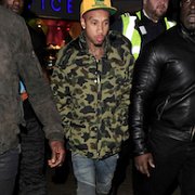 Tyga  Tyga wearing red chucks while out and about with his security.