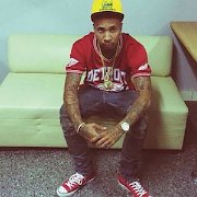 Tyga  Tyga wearing red chucks to match with his Detroit Red Wings shirt.