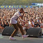 Vince Staples  Vince performing in optical white high top chucks at a festival.