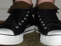 Wearing Rolled Down High Top Chucks  Front view of black and olive foldovers with fat black shoelaces.