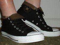 Wearing Rolled Down High Top Chucks  Right side view of black and olive foldovers with fat black laces.