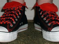Wearing Rolled Down High Top Chucks  Front view of black and red foldovers with red and black laces.