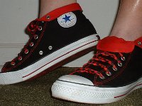 Wearing Rolled Down High Top Chucks  Left view of black and red foldovers with red and black laces.