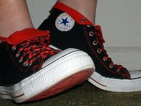 Wearing Rolled Down High Top Chucks  Right side view of black and red foldovers with red and black laces.