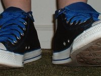 Wearing Rolled Down High Top Chucks  Stepping out in black and royal foldovers with fat royal blue laces.