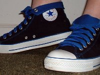 Wearing Rolled Down High Top Chucks  Left side view of black and royal foldovers with fat royal blue laces.