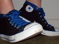 Wearing Rolled Down High Top Chucks  Right side view of black and royal foldovers with fat royal blue laces.