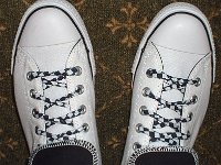 Wearing Rolled Down High Top Chucks  Top view of white and black foldovers laced with black and white checkered shoelaces.