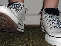 Wearing Rolled Down High Top Chucks  Stepping out in white and black foldovers laced with black and white checkered shoelaces.