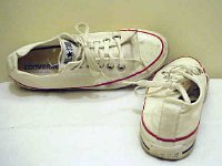 White Low Cut Chucks  Angled rear and top views of worn optical white low cuts.