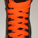 Fat (Wide) Neon Orange Shoelaces on Chucks  Black high top chuck with fat neon orange shoelaces.